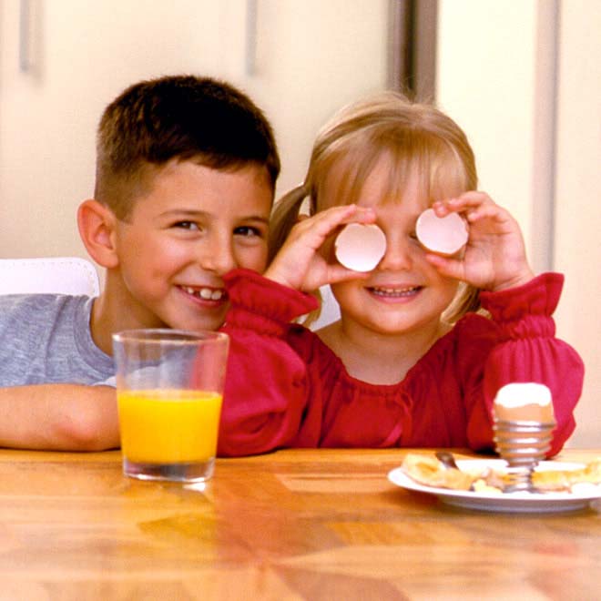 Kids eating eggs and having fun