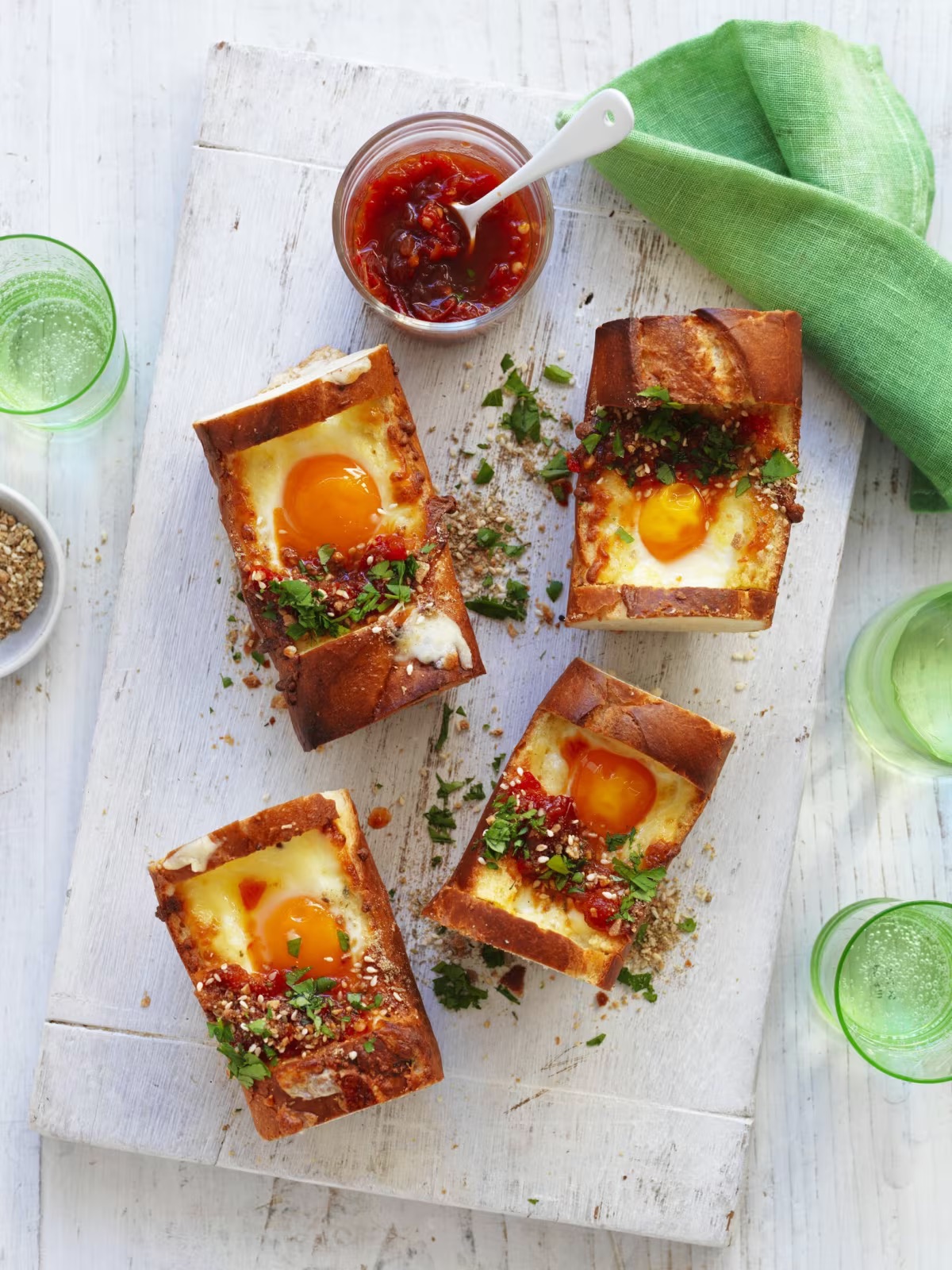 Eggs inside a baguette served with tomato relish